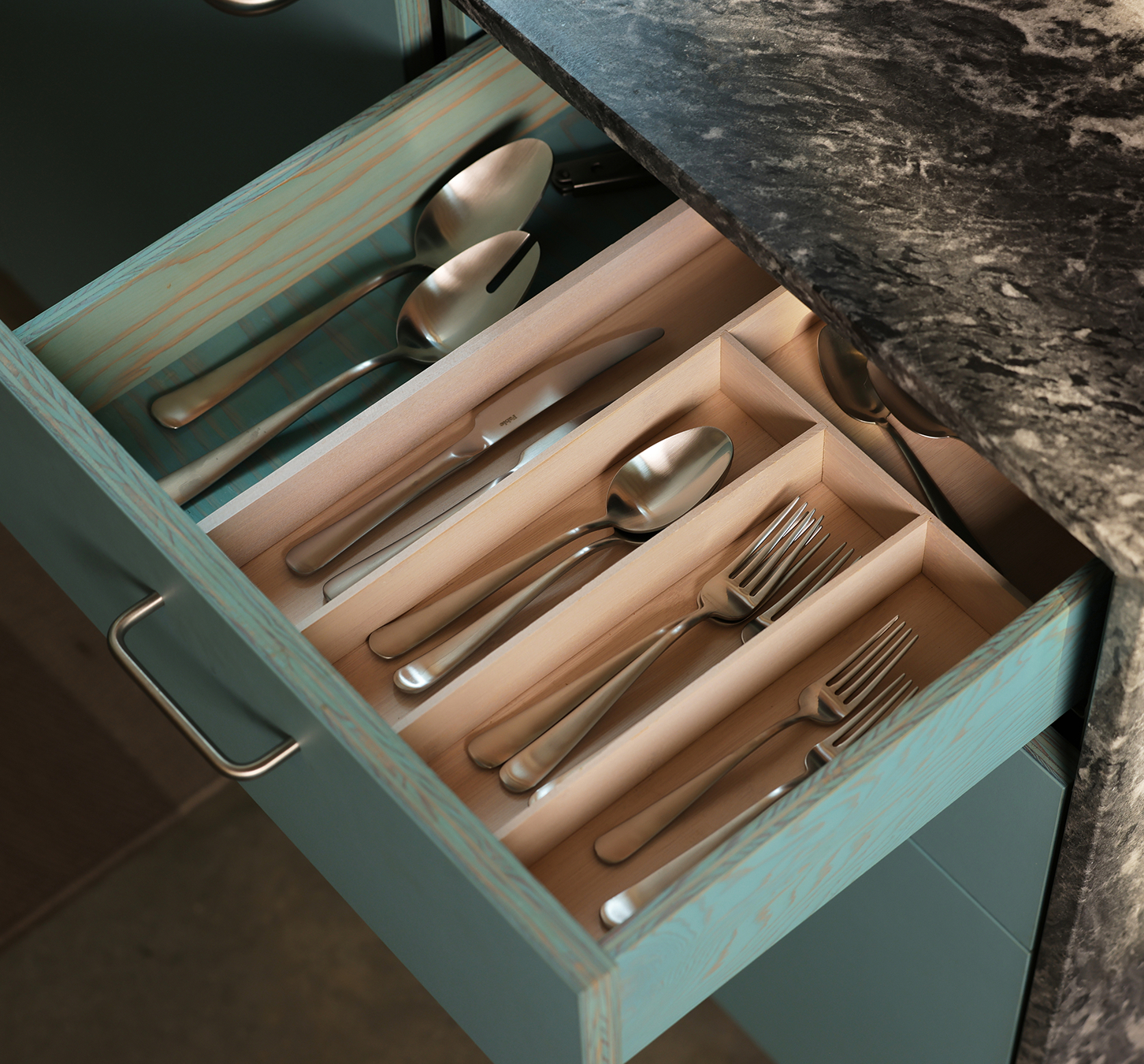 Flatware in blue pull-out drawer