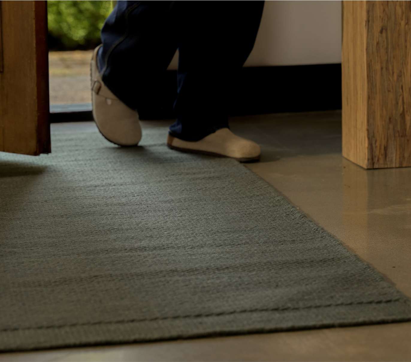 A man is walking on the rug