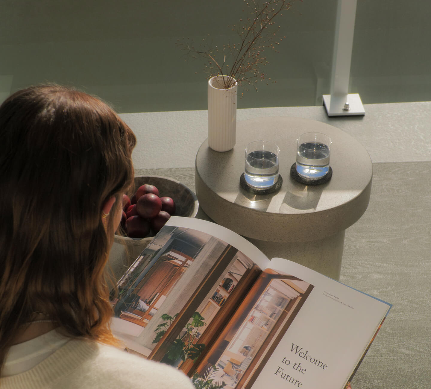 The girl is sitting and reading a book