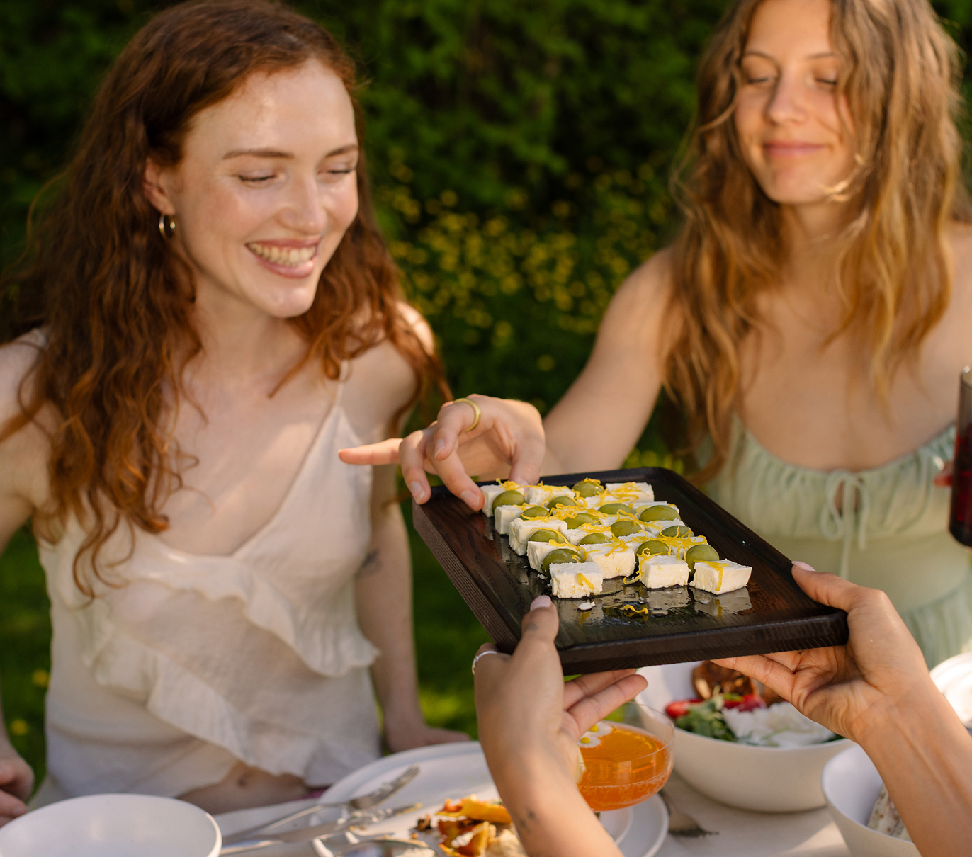 The two young women smile