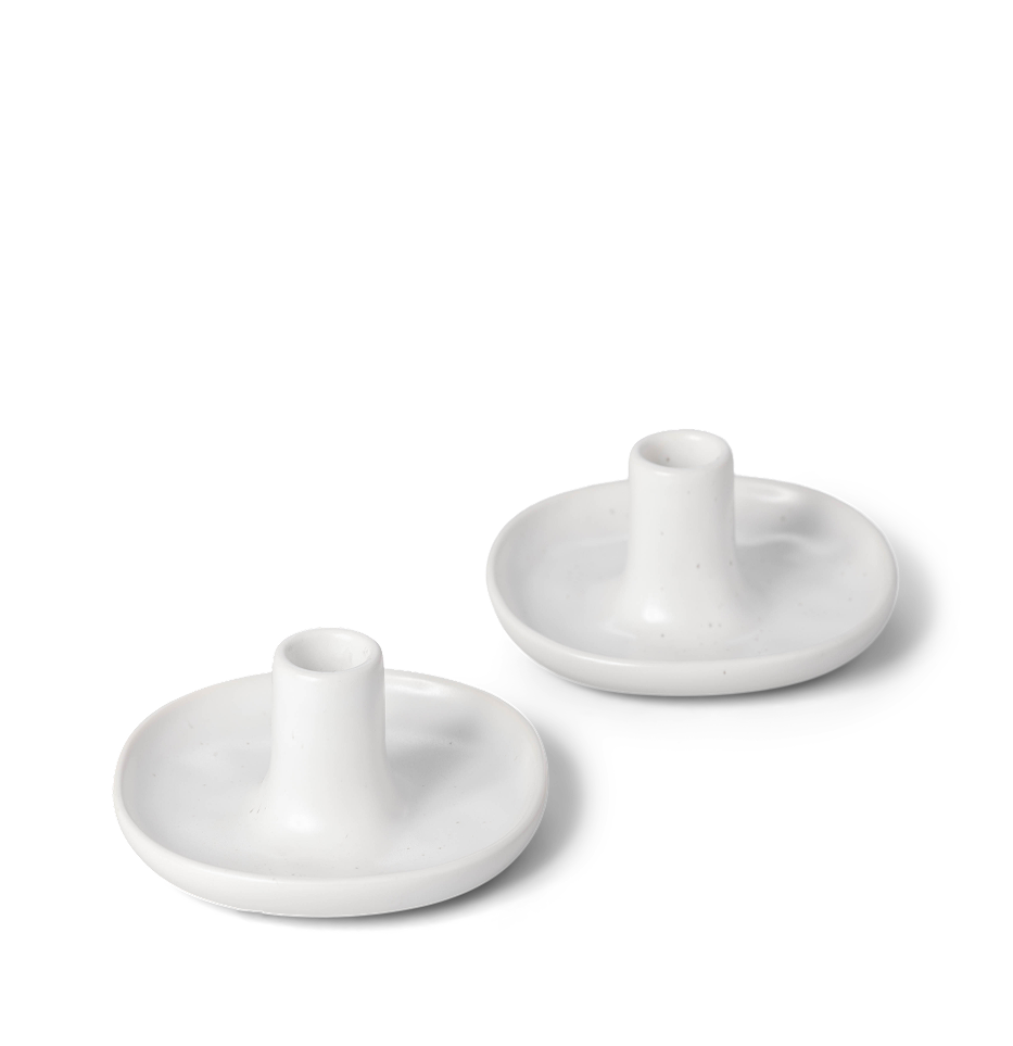 Two white round ceramic holders on a transparent background.