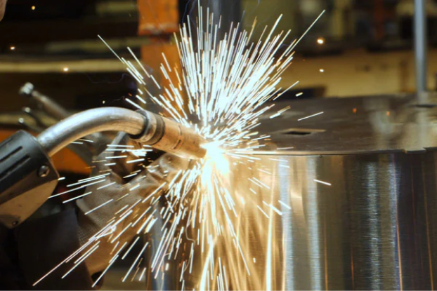 Close-up of welding sparks flying from a metal surface.