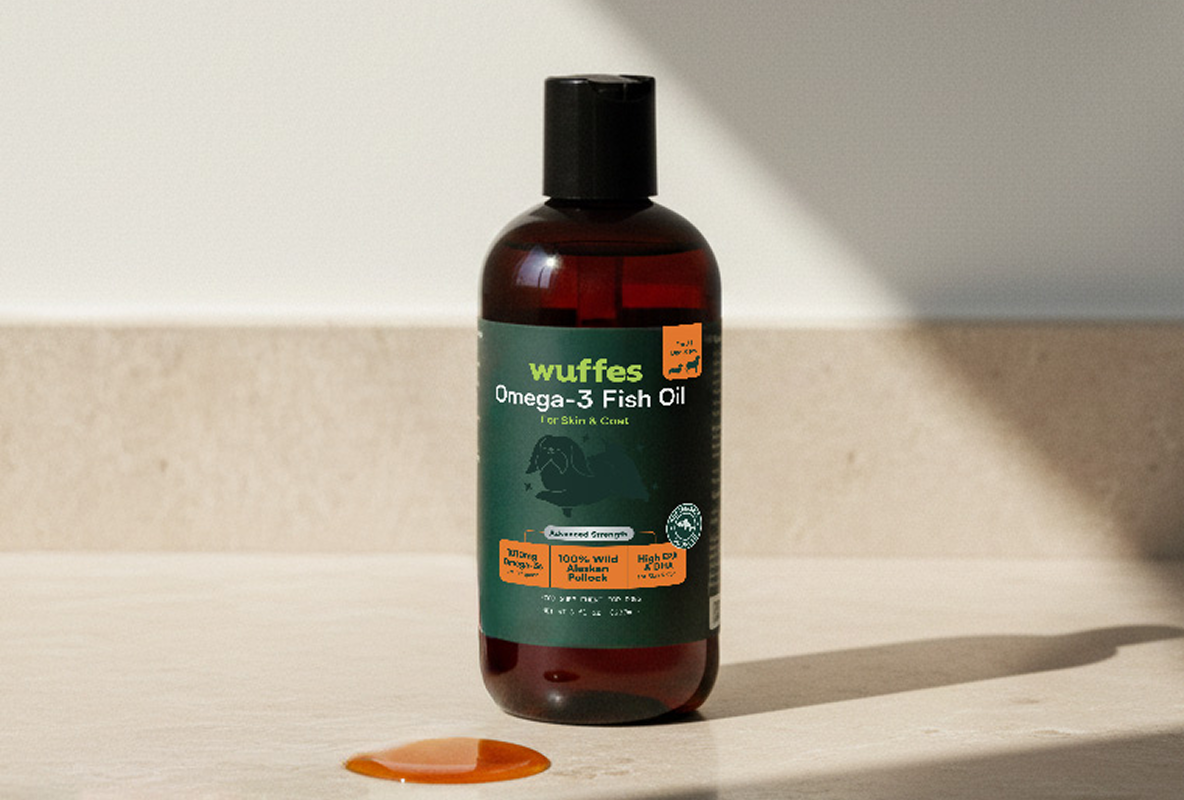 Bottle of Omega-3 Fish Oil with a spilled drop on a countertop.