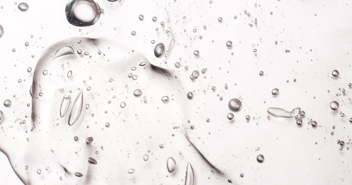 Clear gel with scattered air bubbles on a smooth surface.