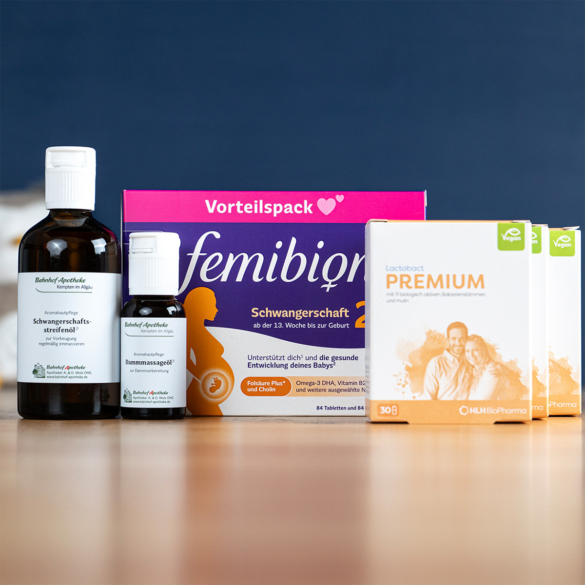 A collection of pregnancy supplements and oils from various German brands arranged on a pharmacy counter.