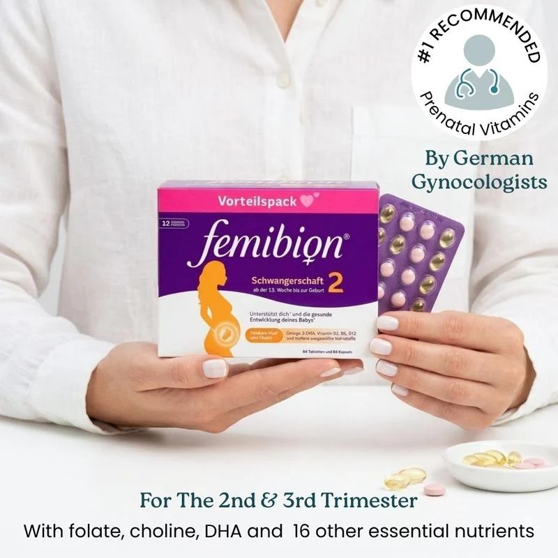 A woman holds a box and blister pack of Femibion 2 prenatal vitamins, with loose pills nearby.