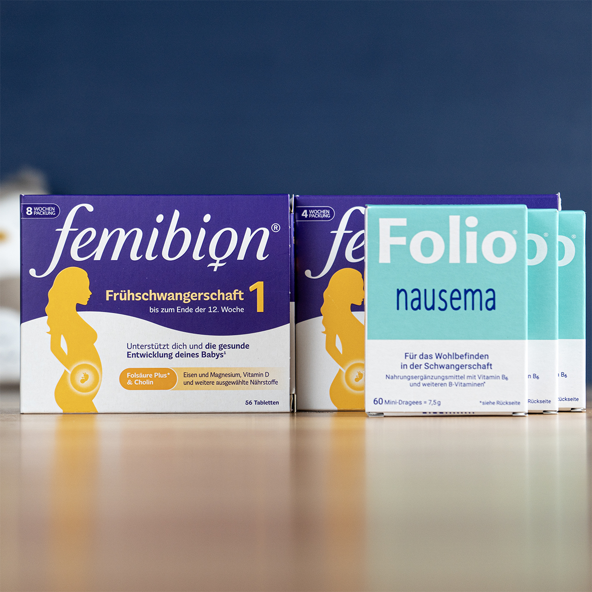 A collection of pregnancy supplements and oils from various German brands arranged on a pharmacy counter.