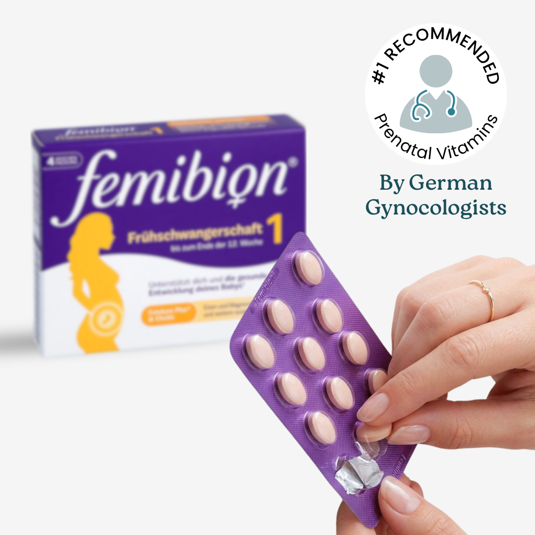 A hand holding a purple blister pack of Femibion prenatal vitamins, with the box in the background.
