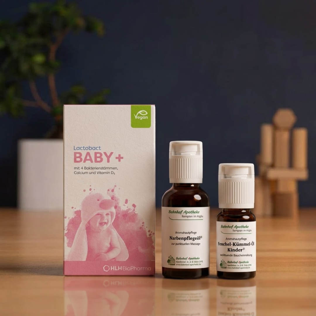 A box of Lactobact BABY+ supplements and two bottles of Bahnhof Apotheke oils on a wooden table.
