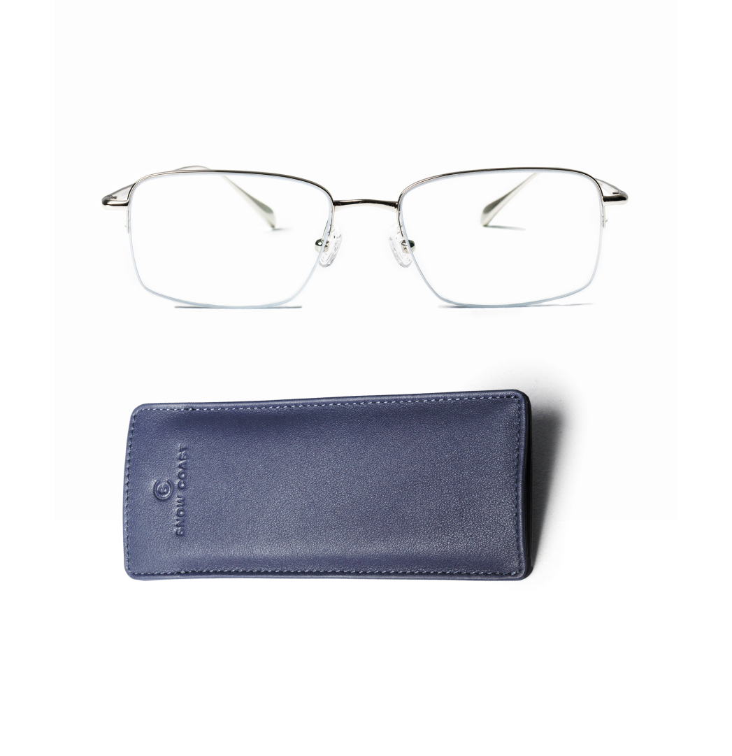 A pair of silver, semi-rimless eyeglasses and a blue leather case on a white background.