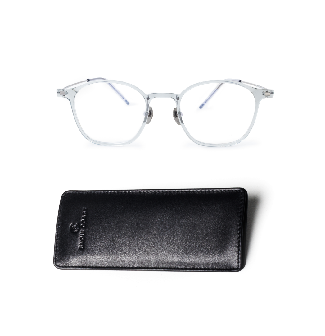 A pair of translucent eyeglasses with a black leather case, shot from above on a white background.