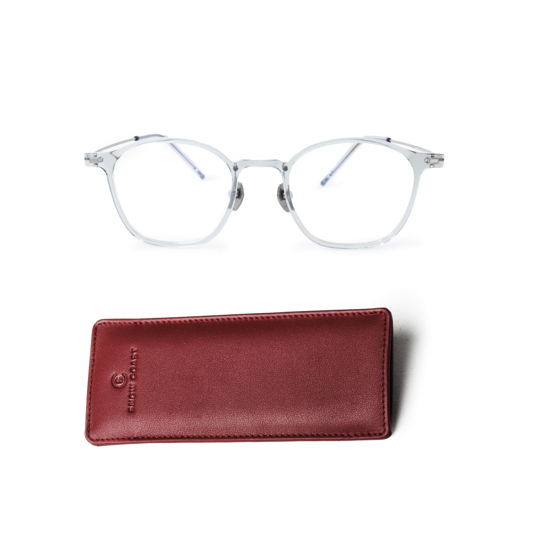 A pair of translucent-framed eyeglasses shown above a red leather glasses case on a white background.