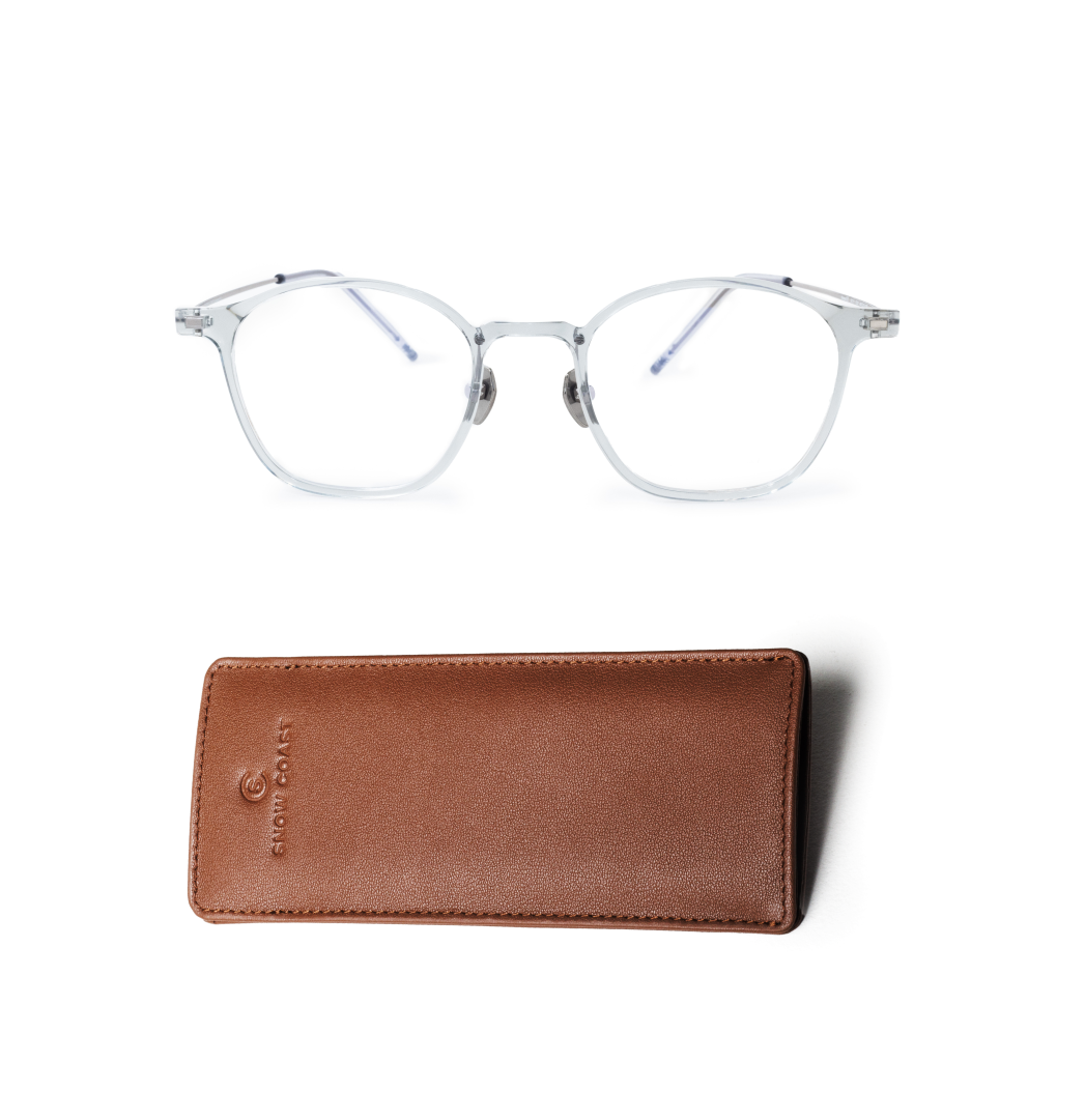 A pair of clear-framed eyeglasses sits above a brown leather carrying case on a white background.