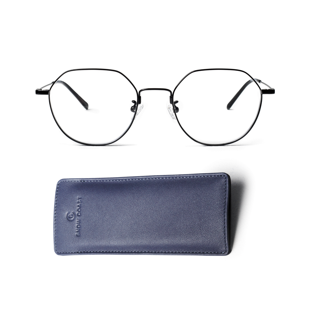 A pair of black, thin-framed geometric eyeglasses sitting above a blue leather case on a white background.