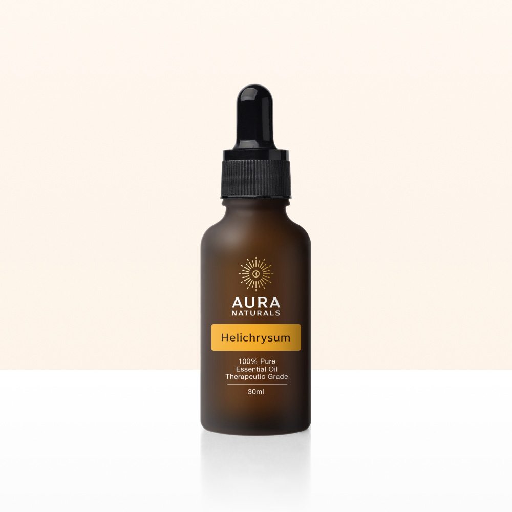 A brown bottle of Aura Naturals Helichrysum essential oil with a black dropper on a two-toned background.