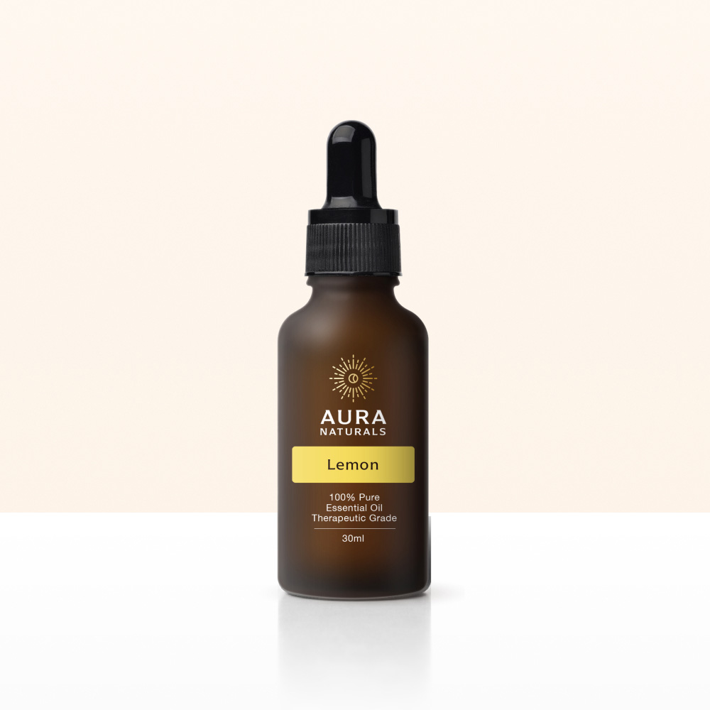 A frosted brown dropper bottle of Aura Naturals Lemon essential oil on a white surface.