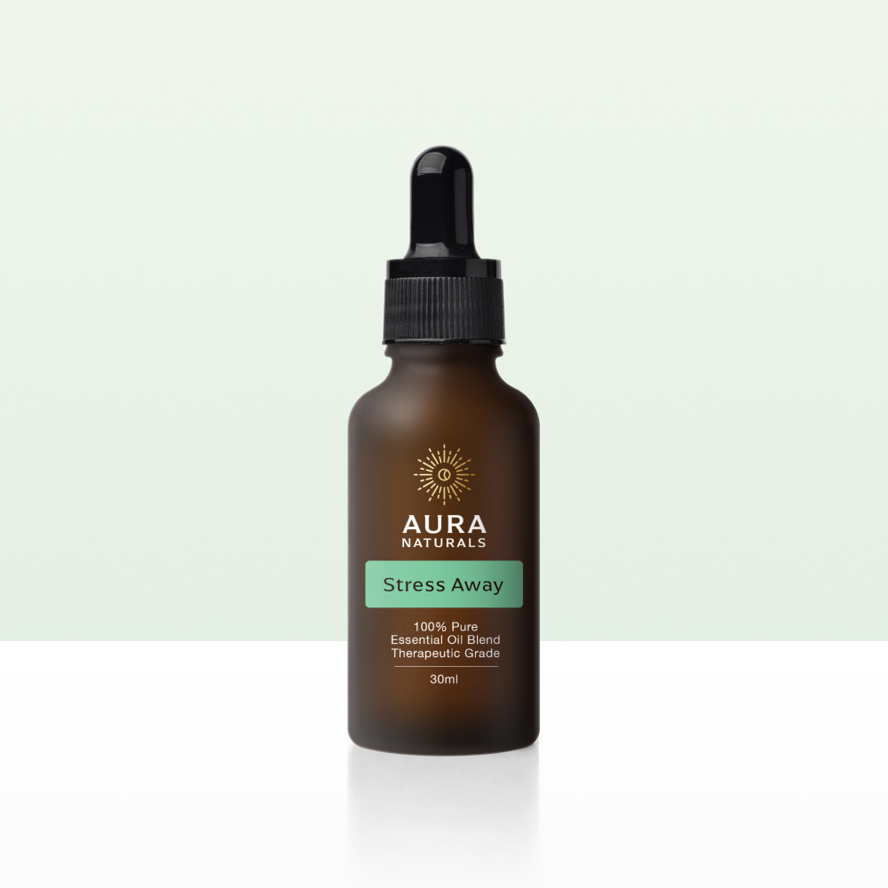 A bottle of Aura Naturals Stress Away essential oil blend against a light green and white background.
