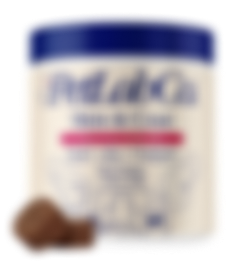 Blurry image of a container with a blue lid and text, next to a brown object.