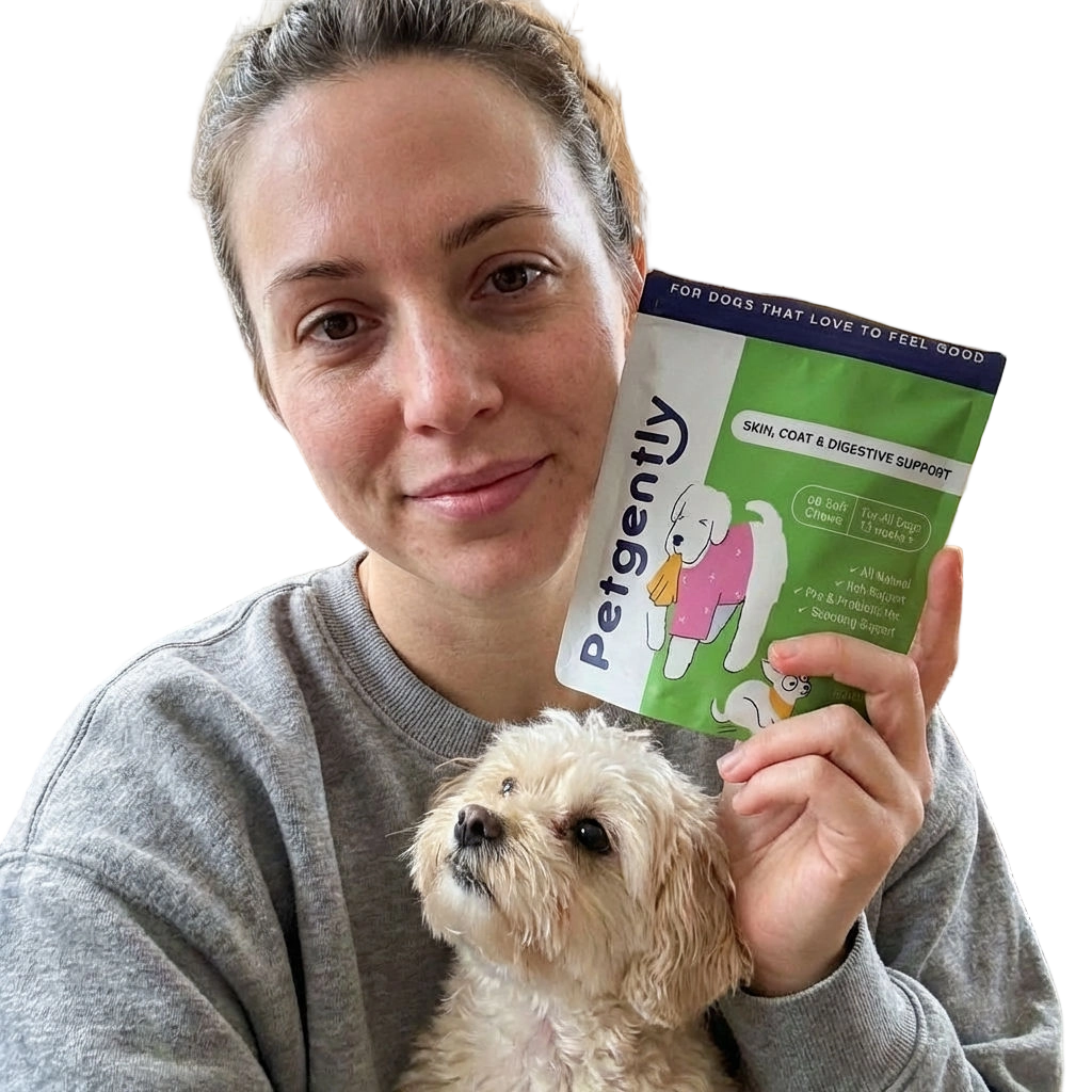 A woman holds a small, light-colored dog and a package of Petgently dog supplements.