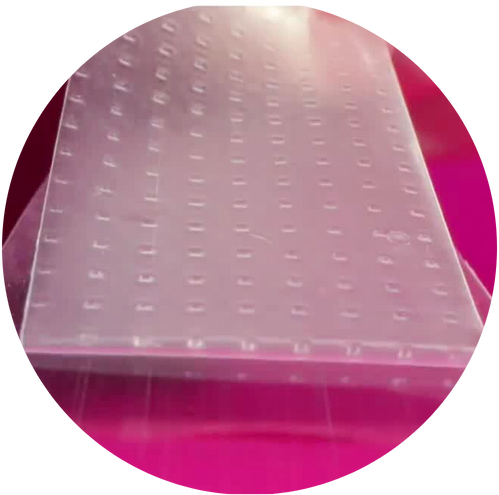 Close-up of a transparent plastic sheet with small raised dots.