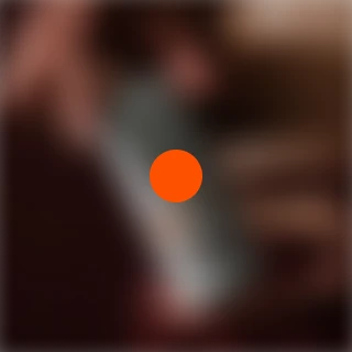 Blurred image with an orange dot in the center.