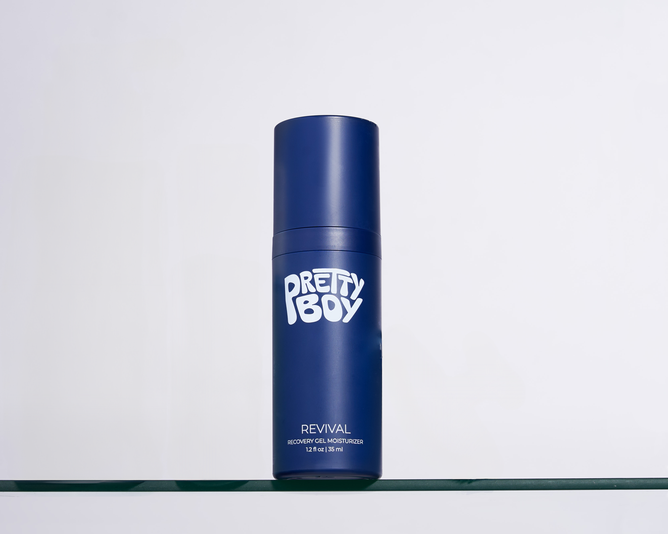 Blue bottle labeled 'Pretty Boy Revival' on a white background.