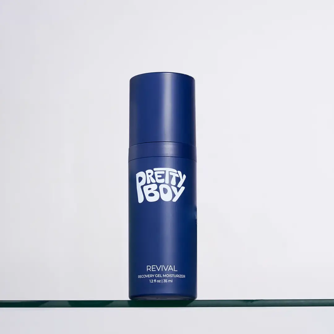 Blue bottle of Pretty Boy Revival gel moisturizer on clear shelf.