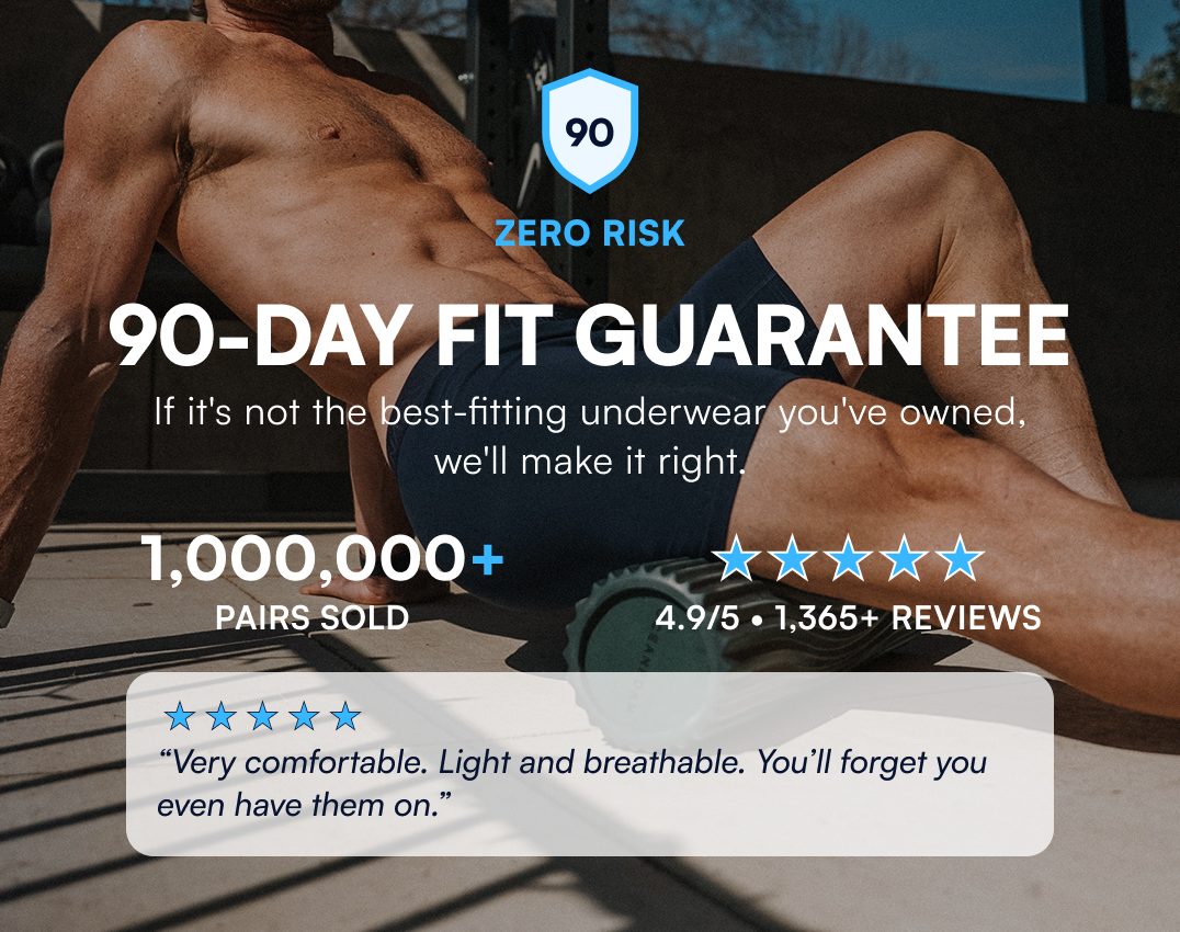 A muscular man in dark boxer briefs uses a foam roller, with ad text for a 90-day fit guarantee.