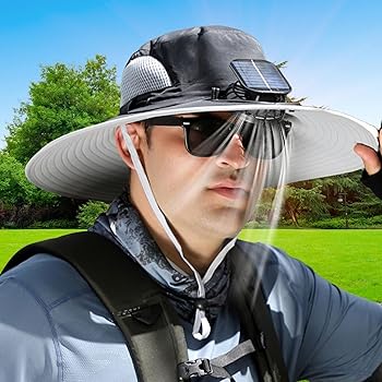 Person outdoors wearing a large hat with solar panel and sunglasses.
