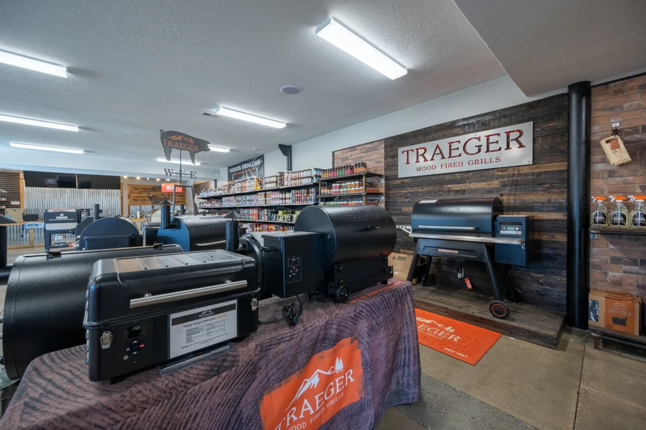 Store interior with Traeger wood-fired grills and shelves of products.