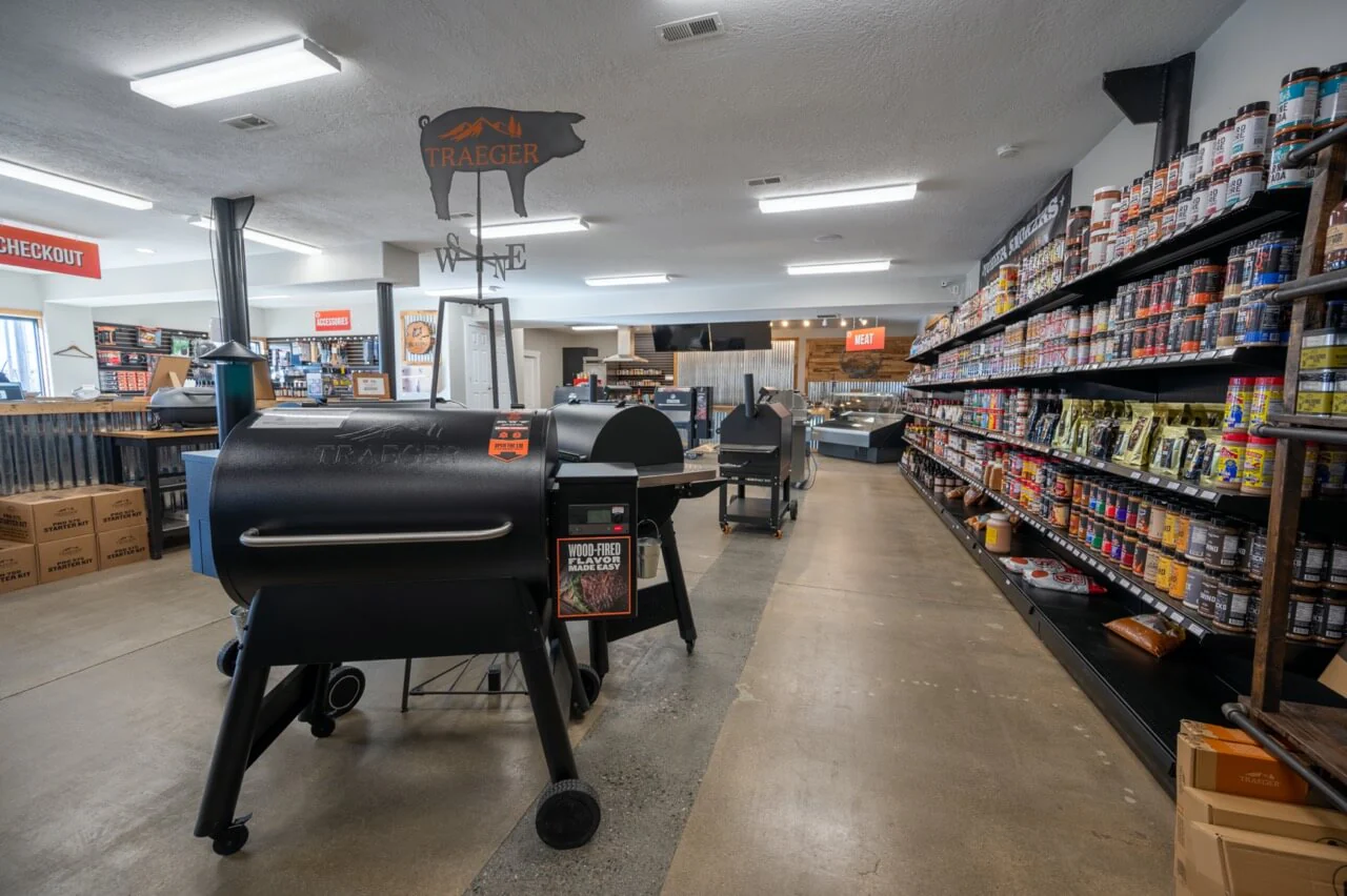 Store interior with Traeger grills and shelves of spices and sauces.