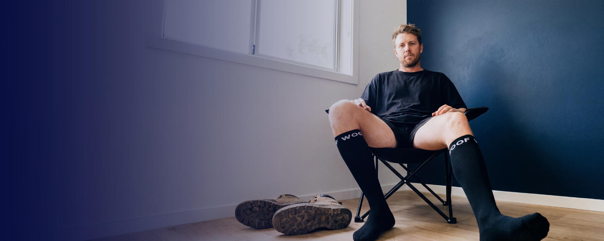 A woman holds a baby wearing a diaper close to her chest.