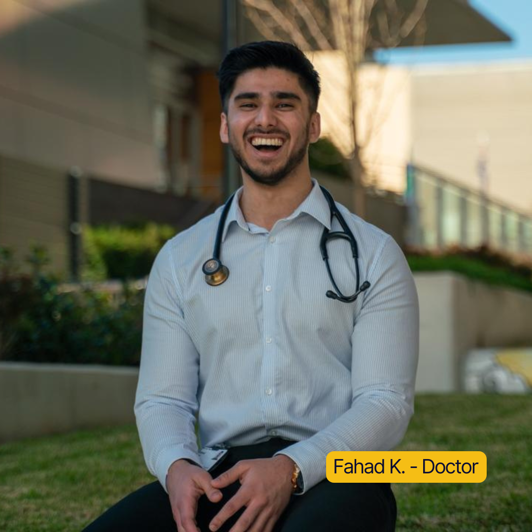 Smiling person with a stethoscope sitting outdoors.