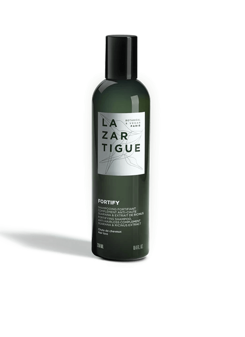 Dark green bottle of Lazartigue Fortify shampoo with white label.