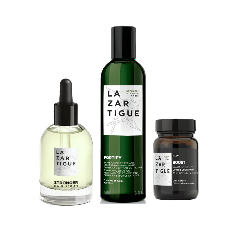 Three Lazartigue hair products including a serum, shampoo, and supplement bottle.