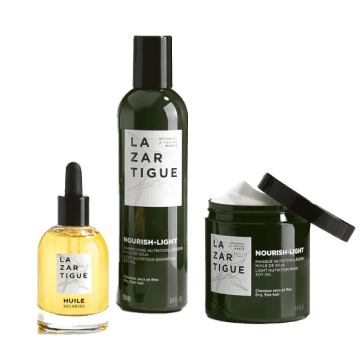 Three Lazartigue hair care products, including oil, shampoo, and cream, on a white background.
