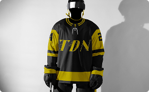 Hockey uniform with black and yellow colors, number 24, and the letters 'TDN' on the jersey.