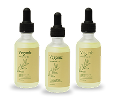 Three bottles of Veganic natural hair oil with droppers.