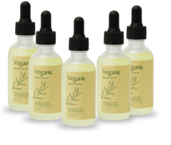 Five bottles of Veganik natural oil with dropper caps.