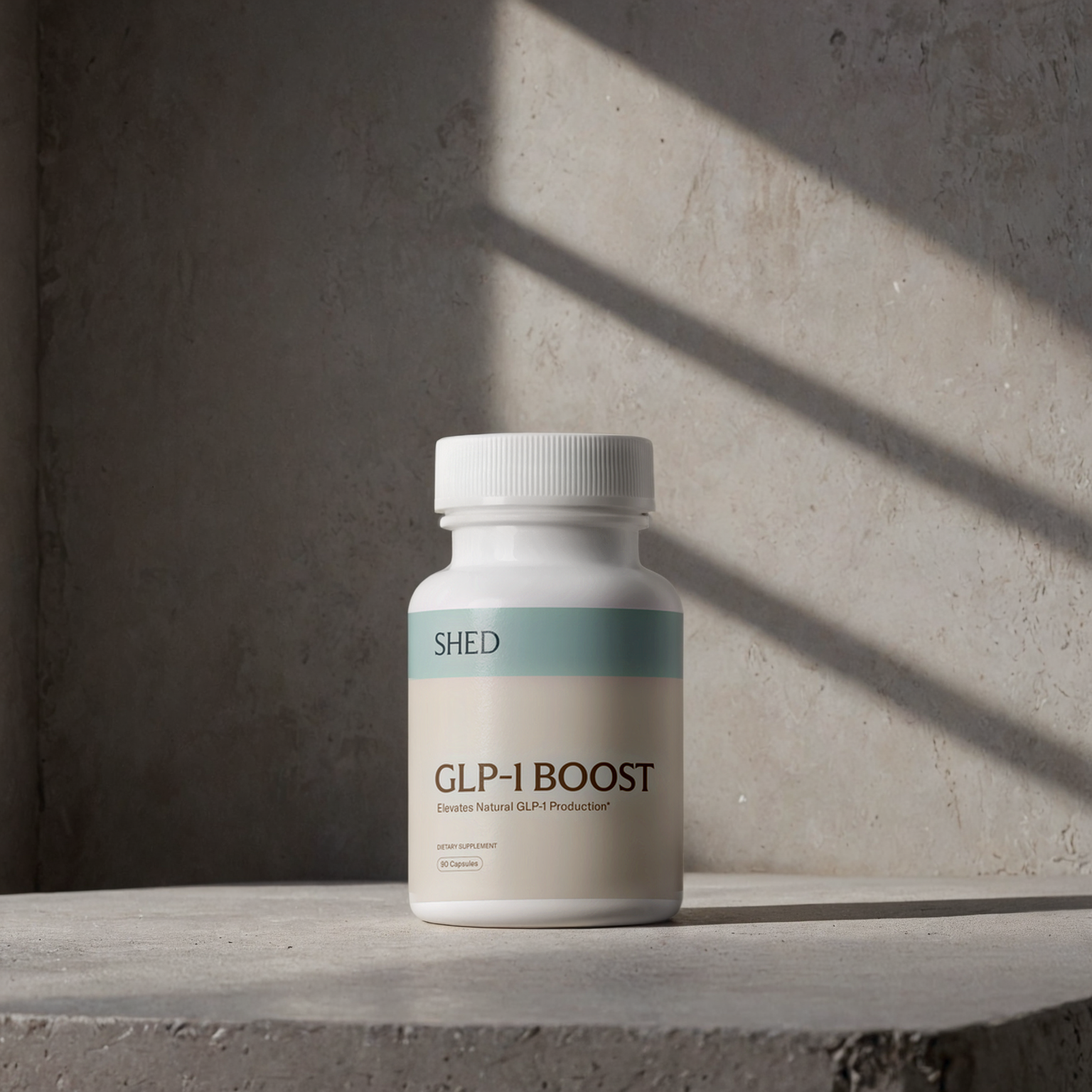 A bottle labeled 'GLP-1 BOOST' on a concrete surface with shadow.