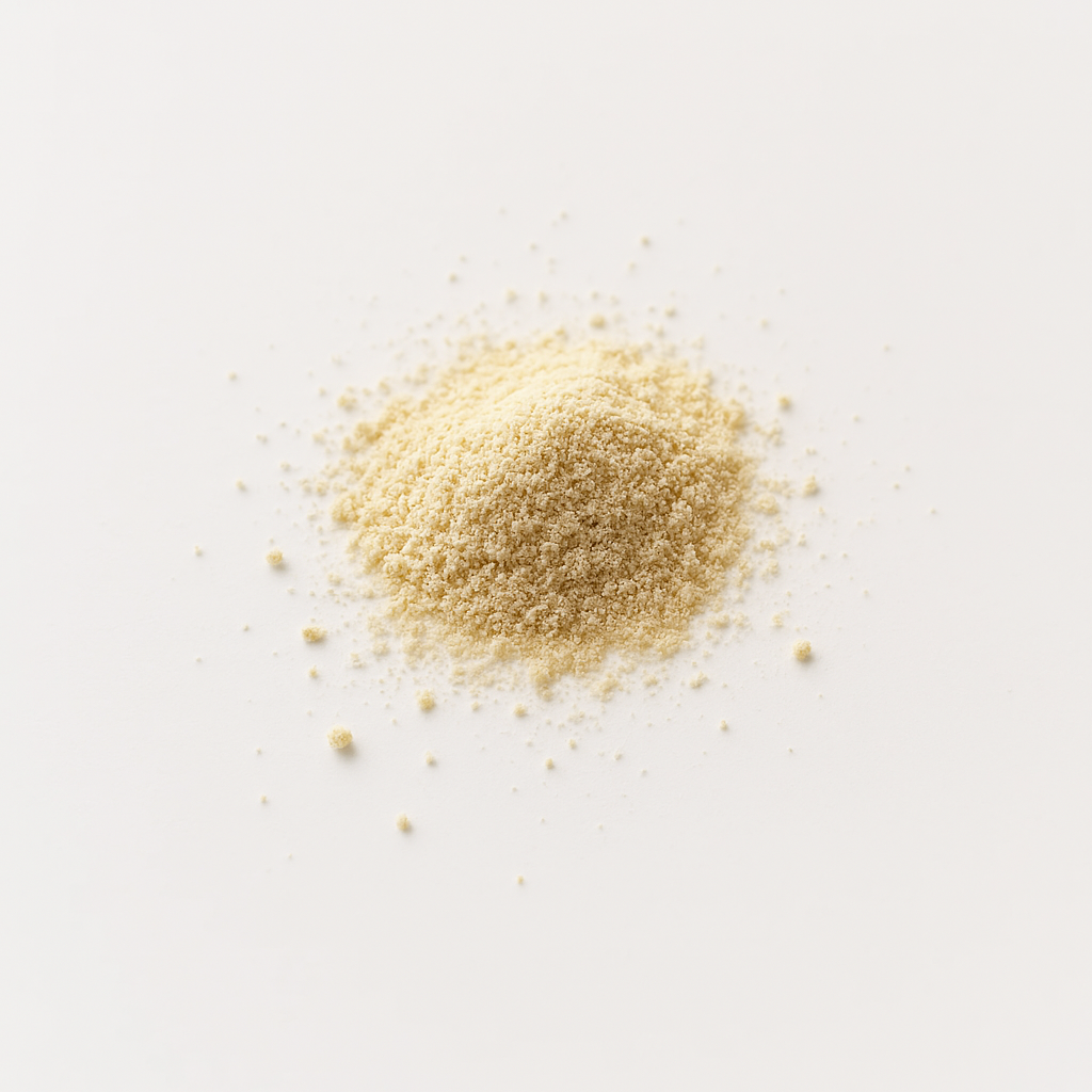 A small pile of beige powder on a white surface.