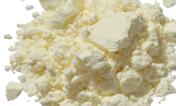 A close-up shot of a pile of light-yellow, clumpy powder on a white background.