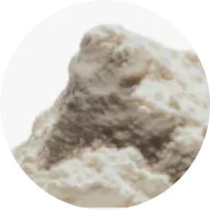 A close-up, circular-cropped image of a small mound of a white, powdery substance.