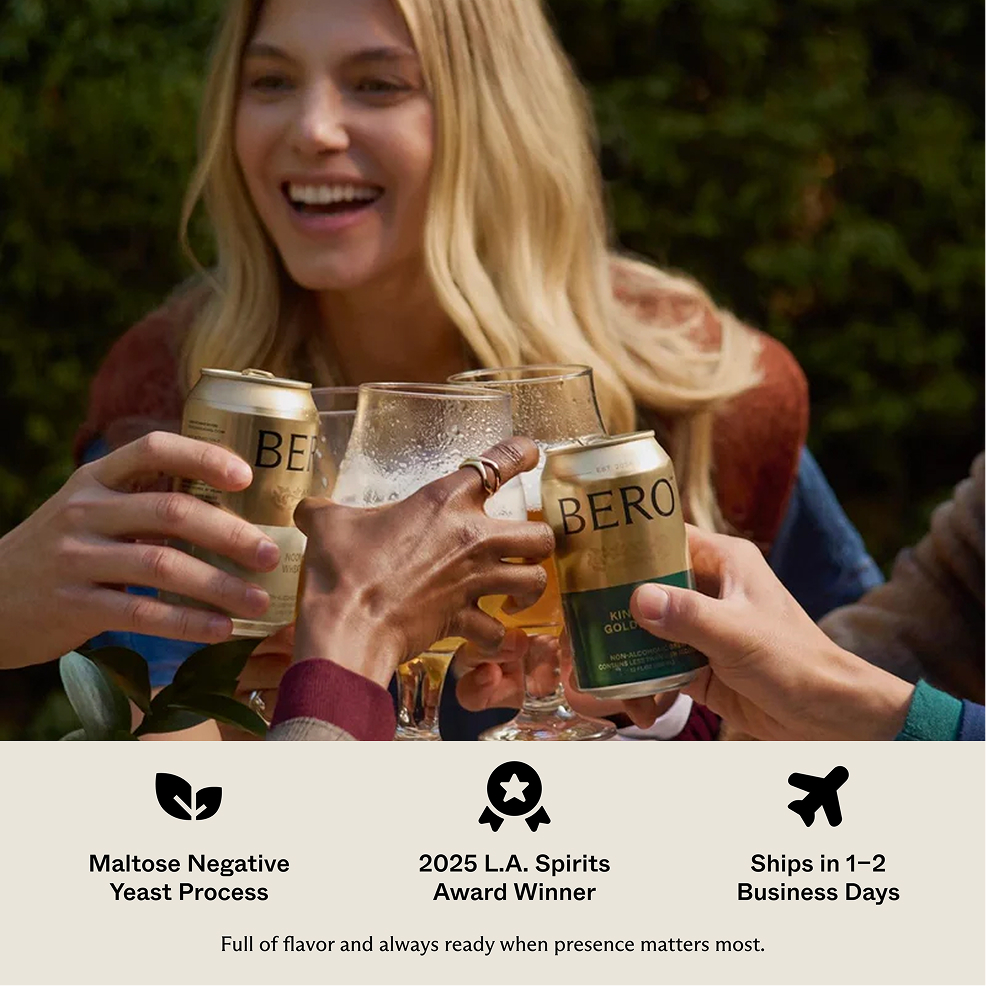 A group of friends toasting outdoors with cans and glasses of BERO beer.