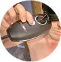 Person using a handheld device on their skin.