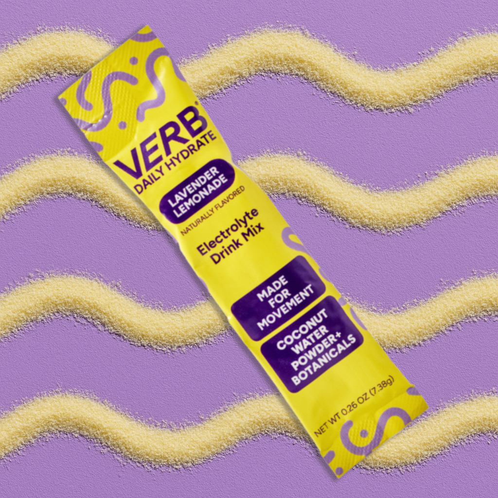 Yellow and purple electrolyte drink mix packet on a textured purple background.