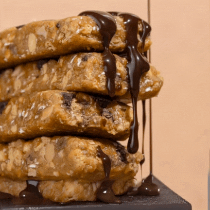 Stack of granola bars with chocolate drizzle.