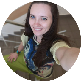 Person taking a selfie on a staircase, wearing a graphic t-shirt.