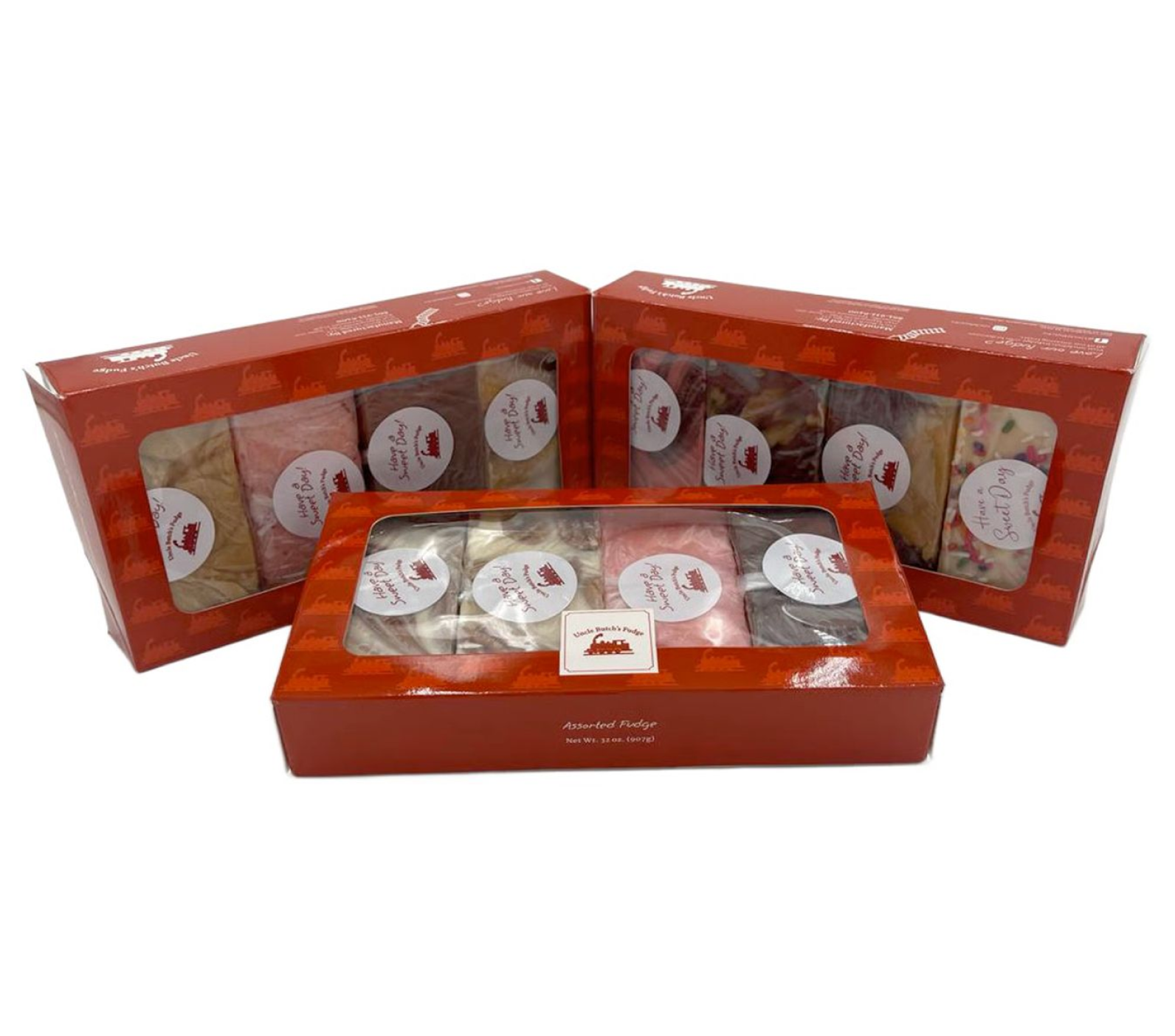 Three red boxes of assorted fudge with clear windows displaying contents.