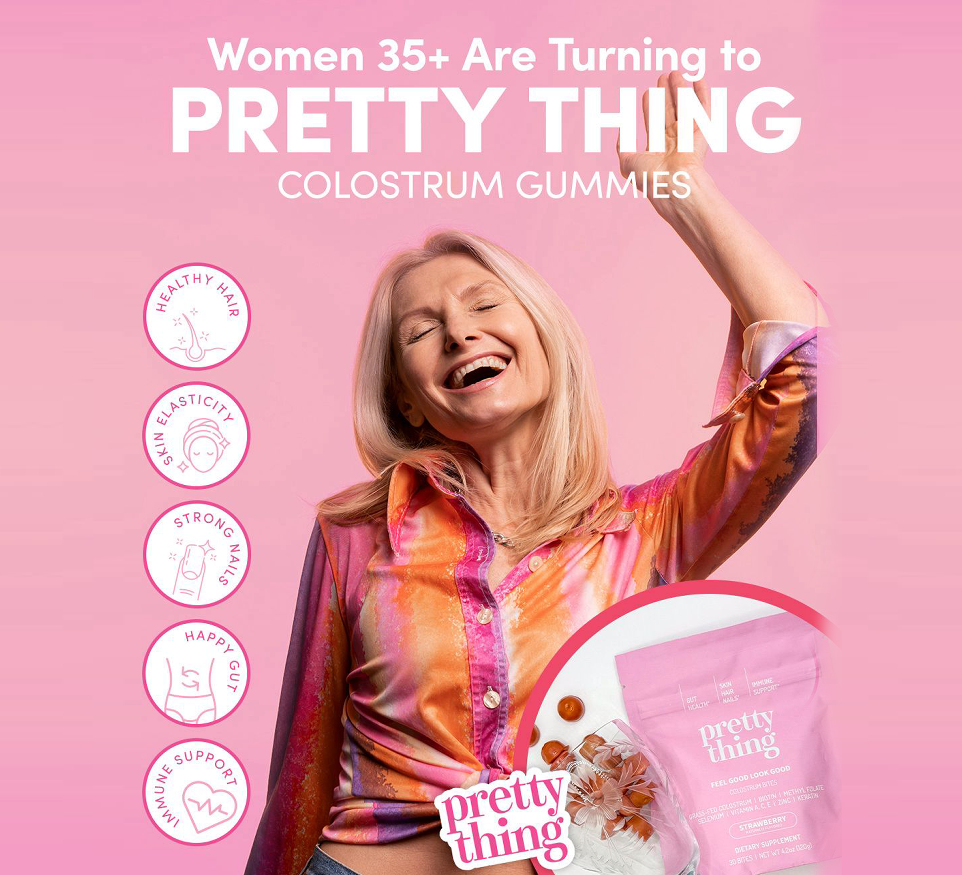 Smiling woman with raised arm, colorful shirt, and colostrum gummies packaging on pink background.